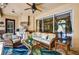 Inviting screened lanai with comfortable seating, outdoor grill, and ceiling fan at 17203 Talence Ct, Tampa, FL 33647