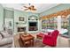 Cozy living room with fireplace, comfortable seating, and large windows offering views of the pool area at 17203 Talence Ct, Tampa, FL 33647