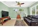 Inviting living room features a comfortable leather sofa, flat-screen TV, and natural light, creating a cozy space at 17203 Talence Ct, Tampa, FL 33647