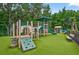 Community playground featuring play structure, climbing area, benches and lush green turf at 17203 Talence Ct, Tampa, FL 33647