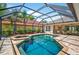 Beautiful screened pool and spa area with stone pavers and lush landscaping at 17203 Talence Ct, Tampa, FL 33647