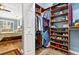 Organized walk-in closet featuring wooden shelving and rods for optimal storage at 17203 Talence Ct, Tampa, FL 33647
