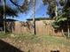 Backyard view of a wooden fence with weeds and debris on the ground at 1835 15Th S Ave, St Petersburg, FL 33712