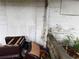 Backyard wall with debris, and old damaged furniture on the ground at 1835 15Th S Ave, St Petersburg, FL 33712