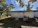 Exterior view of detached building; concrete foundations and overgrown vegetation at 1835 15Th S Ave, St Petersburg, FL 33712