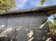 Exterior view of the detached building with closed up windows and overgrown vegetation at 1835 15Th S Ave, St Petersburg, FL 33712