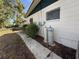Exterior of home featuring white siding and foliage at 1835 15Th S Ave, St Petersburg, FL 33712