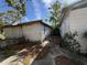 Exterior side view of two white buildings with peeling paint in need of repair at 1835 15Th S Ave, St Petersburg, FL 33712