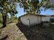 Exterior view of detached building; concrete foundations and overgrown vegetation at 1835 15Th S Ave, St Petersburg, FL 33712
