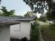 View of the building exterior with trees and foliage, and a street beyond the lawn at 1835 15Th S Ave, St Petersburg, FL 33712