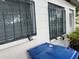 Exterior view of the side of the building with a blue trash can and bars on the windows at 1835 15Th S Ave, St Petersburg, FL 33712