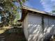 Exterior side view of the house showing peeling paint and vegetation growing on the side at 1835 15Th S Ave, St Petersburg, FL 33712