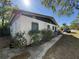 Exterior side view of the home with bushes, bars on the windows and a truck in the street at 1835 15Th S Ave, St Petersburg, FL 33712