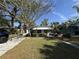 Charming home featuring a well-manicured lawn, awning, and mature landscaping creating lovely curb appeal at 1835 15Th S Ave, St Petersburg, FL 33712