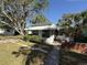 Quaint home featuring mature trees, front yard, and covered porch area at 1835 15Th S Ave, St Petersburg, FL 33712