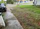 View of the front yard and the street in front of the house with a car parked at the curb at 1835 15Th S Ave, St Petersburg, FL 33712
