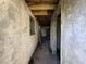 Hallway features exposed wooden beams and concrete walls, offering renovation potential at 1835 15Th S Ave, St Petersburg, FL 33712