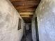Hallway features exposed wooden beams and concrete walls, offering renovation potential at 1835 15Th S Ave, St Petersburg, FL 33712