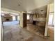 Image of a kitchen with dated cabinets and appliances adjacent to living room with fireplace, needing renovation at 1835 15Th S Ave, St Petersburg, FL 33712