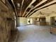 Wide-angle view of home interior featuring a fireplace and exposed ceiling beams, offering a renovation opportunity at 1835 15Th S Ave, St Petersburg, FL 33712