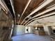 Interior of home with stone fireplace and exposed ceiling beams, offering potential for a modern renovation project at 1835 15Th S Ave, St Petersburg, FL 33712