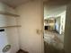 Image of a pantry with wire shelving, next to a kitchen with dated appliances, requiring renovation at 1835 15Th S Ave, St Petersburg, FL 33712