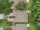 Aerial view of a well maintained home with manicured lawn, mature trees, and a neutral-toned roof at 19204 Weymouth Dr, Land O Lakes, FL 34638