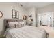 This bedroom features a unique decor style with a hanging plant, decorative mirror and accent table at 19204 Weymouth Dr, Land O Lakes, FL 34638