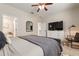 Bedroom showing bathroom access, dresser and television, plus a modern armchair at 19204 Weymouth Dr, Land O Lakes, FL 34638