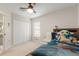 This bedroom features a ceiling fan, closet, and a window letting in natural light at 19204 Weymouth Dr, Land O Lakes, FL 34638