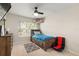 Cozy bedroom featuring a bed with built-in storage and a ceiling fan at 19204 Weymouth Dr, Land O Lakes, FL 34638