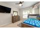 Bedroom with a window view, dresser, and ceiling fan at 19204 Weymouth Dr, Land O Lakes, FL 34638