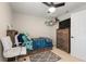 This bedroom boasts an accent rug, ceiling fan, and a TV atop a wooden dresser at 19204 Weymouth Dr, Land O Lakes, FL 34638