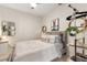 This bedroom features a unique decor style with a hanging plant, decorative mirror and accent table at 19204 Weymouth Dr, Land O Lakes, FL 34638