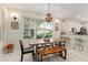 Dining room boasting lots of light and wood table next to bar seating and cabinets at 19204 Weymouth Dr, Land O Lakes, FL 34638