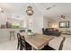 Bright dining room with wood table and seating adjacent to the living room at 19204 Weymouth Dr, Land O Lakes, FL 34638