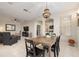 Open-concept dining area featuring an elegant chandelier at 19204 Weymouth Dr, Land O Lakes, FL 34638
