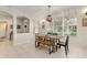 Bright dining space with natural light, wooden table and stylish chandelier at 19204 Weymouth Dr, Land O Lakes, FL 34638