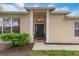 Inviting front entrance with a stylish black door and manicured landscaping at 19204 Weymouth Dr, Land O Lakes, FL 34638