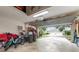 Open garage with storage items; view of the front yard and neighboring homes at 19204 Weymouth Dr, Land O Lakes, FL 34638