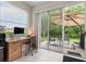 Functional home office with a view of the outdoor patio and lush greenery at 19204 Weymouth Dr, Land O Lakes, FL 34638