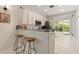 Well-lit kitchen with white cabinets, stainless steel appliances and bar seating at 19204 Weymouth Dr, Land O Lakes, FL 34638