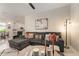 Comfortable living room featuring a stylish gray sectional sofa and modern decor at 19204 Weymouth Dr, Land O Lakes, FL 34638