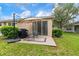 Back patio with seating and grill, perfect for outdoor dining and entertaining at 19204 Weymouth Dr, Land O Lakes, FL 34638
