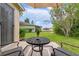 Comfortable outdoor patio set with umbrella, overlooking a well maintained backyard and a tranquil pond view at 19204 Weymouth Dr, Land O Lakes, FL 34638