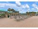 Community pool deck featuring many lounge chairs and tables under shaded pavilions, surrounded by many palm trees at 19204 Weymouth Dr, Land O Lakes, FL 34638