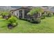 Landscaped backyard featuring a screened-in lanai and lush greenery, offering a private retreat at 20025 Callisto Hill Pl, Tampa, FL 33647