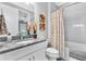 Clean bathroom with a granite vanity, white tiled shower, and tasteful decor at 20025 Callisto Hill Pl, Tampa, FL 33647