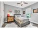 Comfortable bedroom boasts a ceiling fan, plush bed, and charming decor, creating a relaxing retreat at 20025 Callisto Hill Pl, Tampa, FL 33647