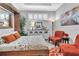 Cozy bedroom features a murphy bed, bright chairs, and white shutters for comfortable living at 20025 Callisto Hill Pl, Tampa, FL 33647